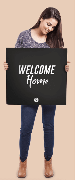 girl holding sign that says welcome home